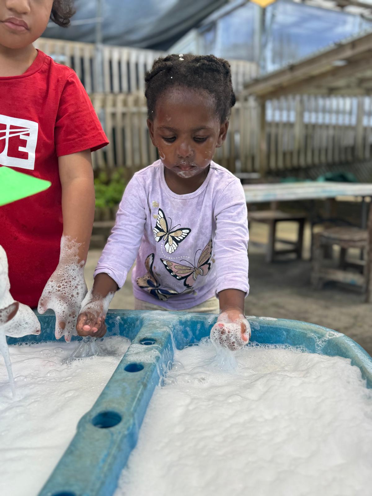Child painting at Little Village