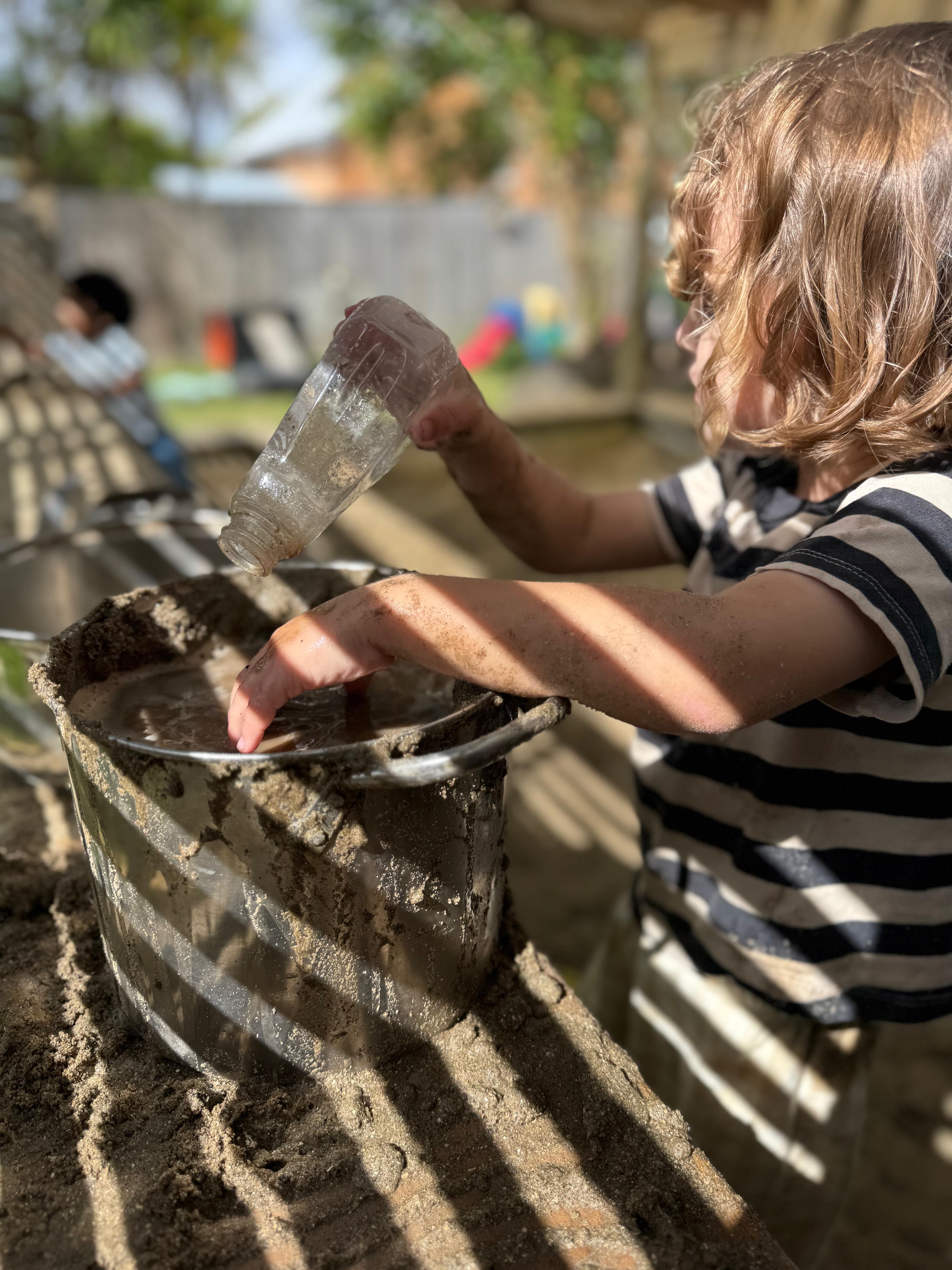 Child having fun during water play outdoors