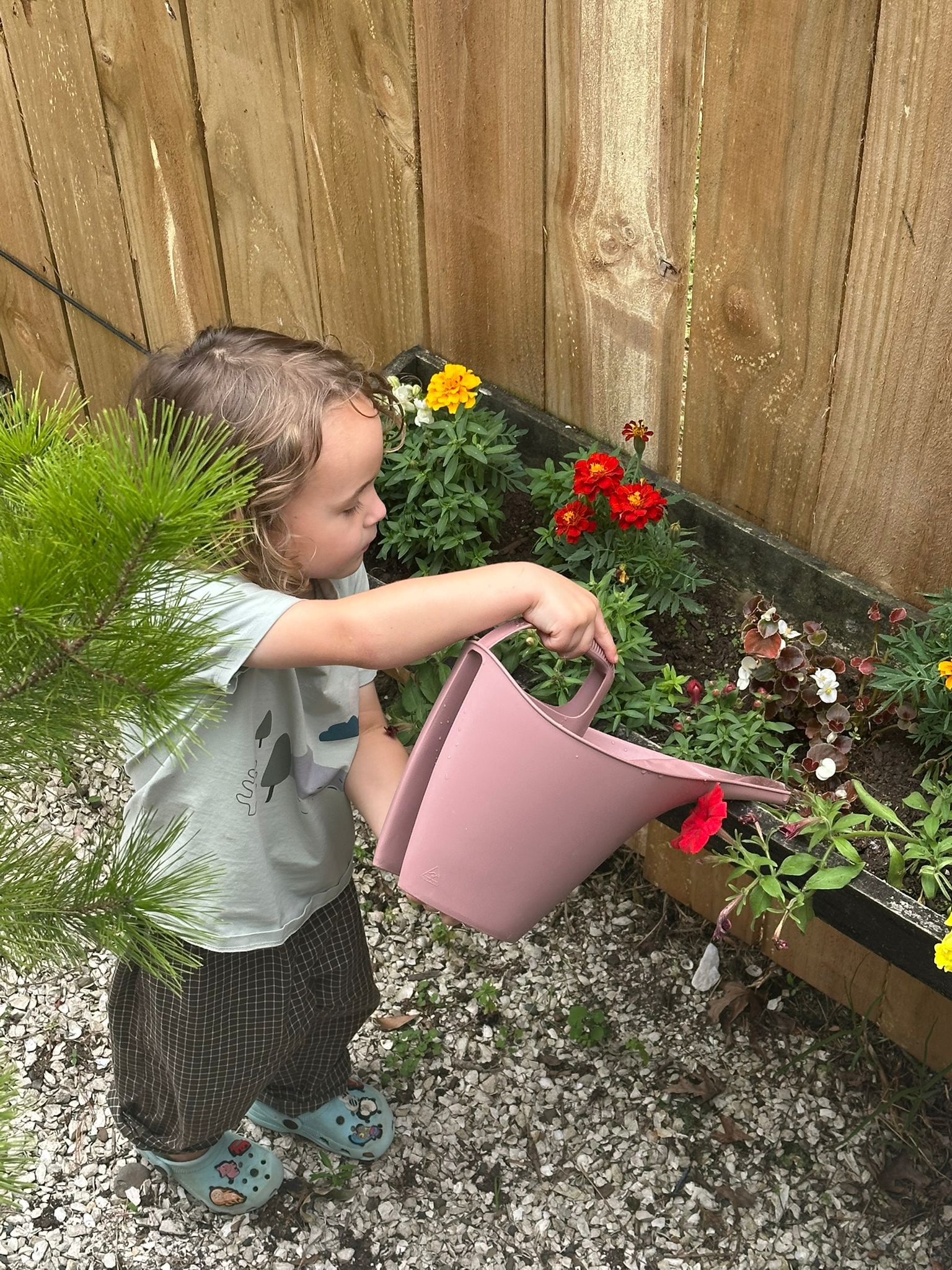Child exploring nature at Little Village Preschool